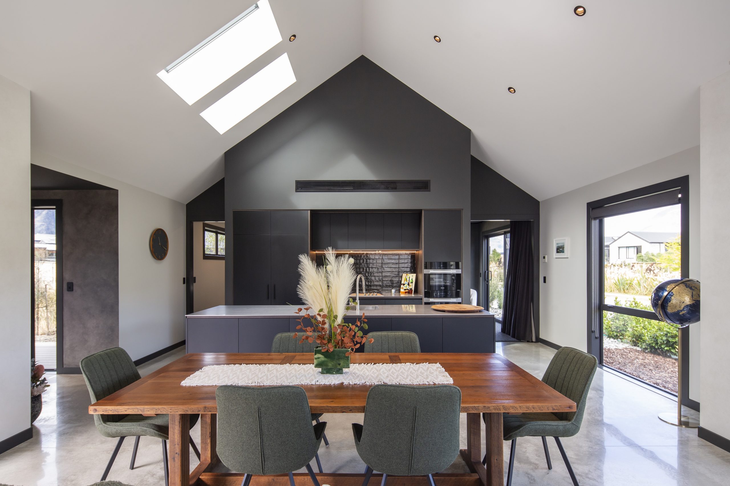 Vaulted open-plan kitchen and dining area with skylights, 27 Drysdale holiday home, Queenstown